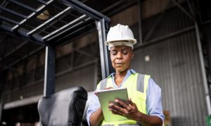 Mature woman working on a digital tablet in a warehouse