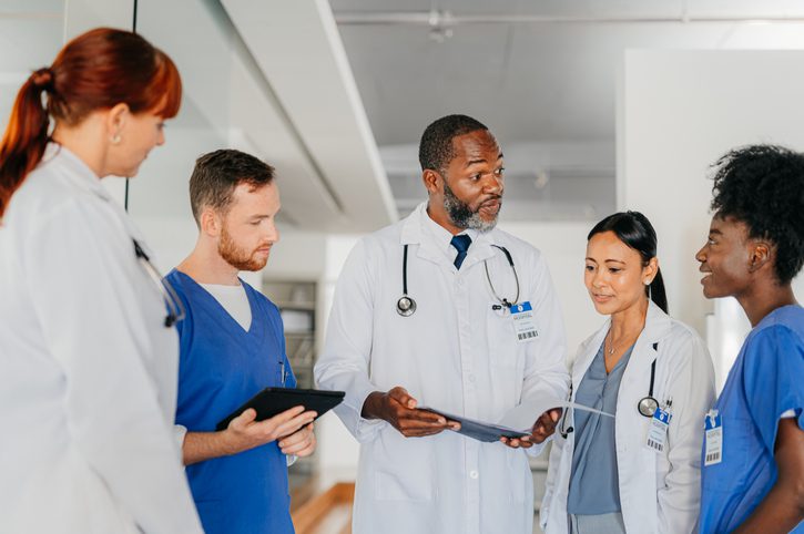 Group of healthcare professionals having a discussion in a hospital.