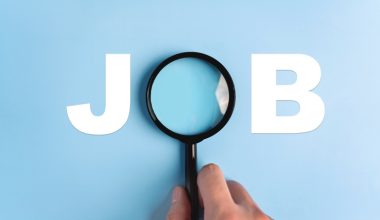 The word "JOB" with a magnifying glass over the "O" on a blue background.