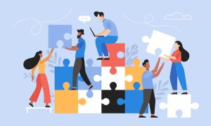 Illustration of people stacking large colorful puzzle pieces together.