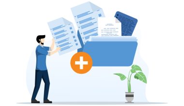 Man placing large documents into a blue folder with a plus sign, next to a potted plant.