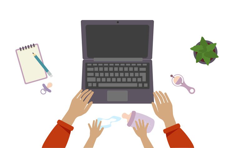 Top-down view of a workspace with a laptop, baby items, and adult and child hands reaching for a bottle.