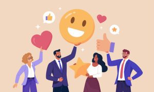 Four business professionals standing together holding large icons representing positive feedback, including a smiling emoji, a heart, a star, and a thumbs-up symbol, with speech bubbles showing likes and ratings.