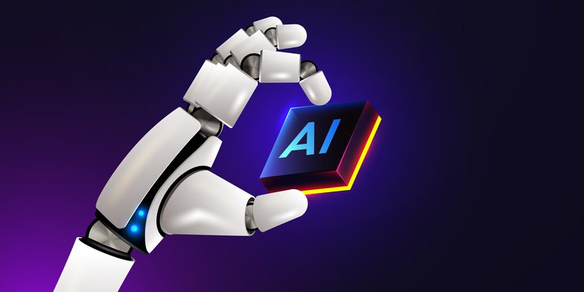 A robotic hand holding a glowing cube labeled “AI” against a dark, futuristic background.
