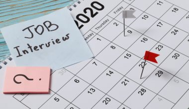 Professional workspace with notebooks, pens, and a calendar, symbolizing organized communication and the process of professionally rescheduling a job interview.