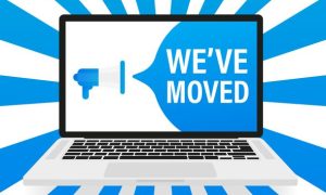 Illustration of a laptop displaying a blue megaphone and the text “WE’VE MOVED,” with blue and white radial rays emanating in the background.